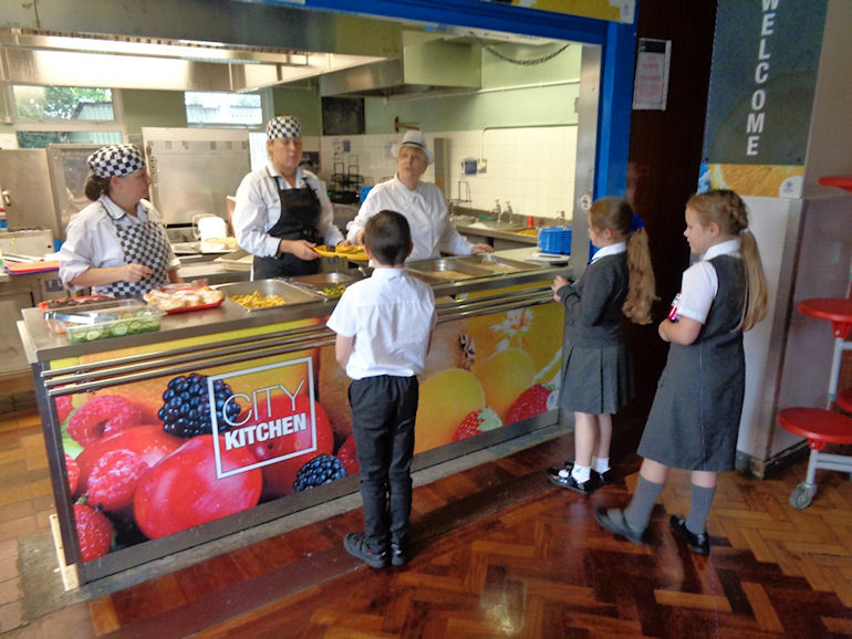 Children choosing their school meals at the counter